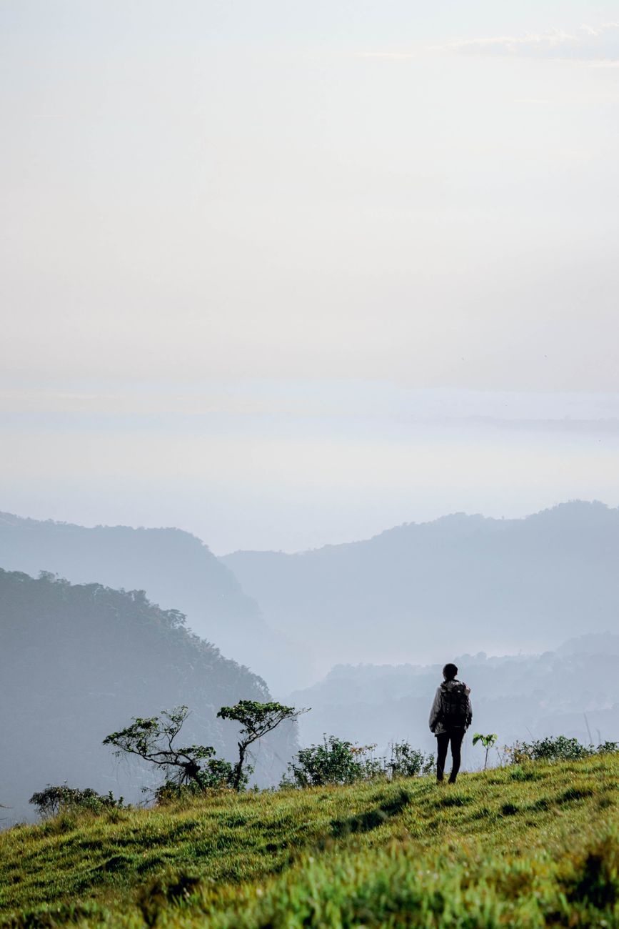 Traveler looking across expansive serene landscape