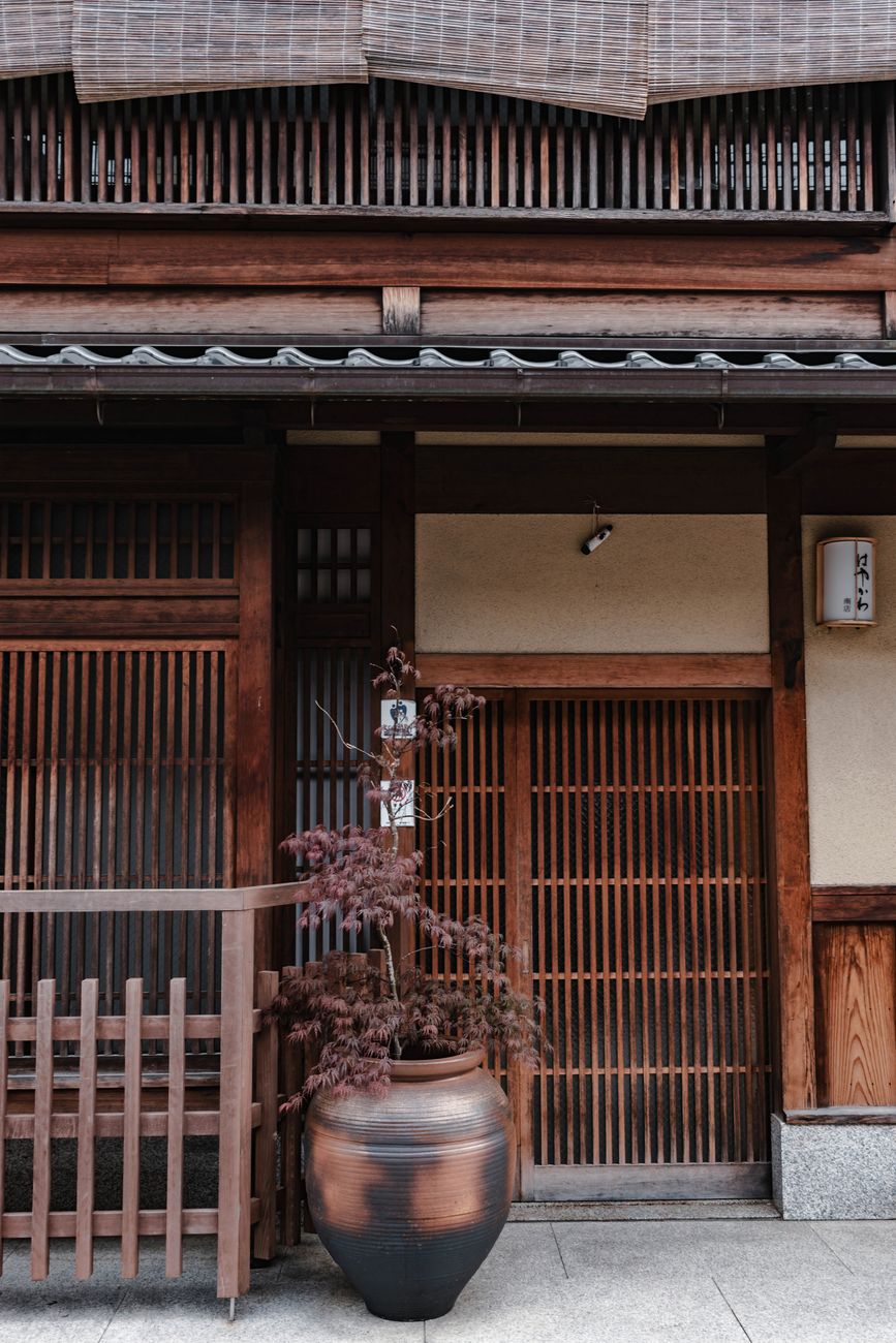 Traditional Japanese wooden machiya and stone lantern